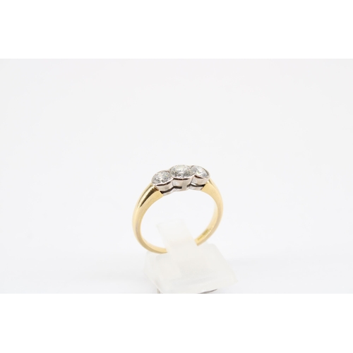 11 - An 18ct Diamond Three Stone Ring, Featuring Three Bezel Set Round Brilliant Diamonds .65ct, VS2/SI1,... 