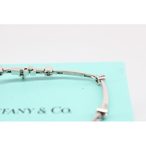 14 - A brilliant cut diamond collet and knife edge bar bracelet. Estimated diamond weight 0.60ct. Diamete... 