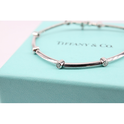 14 - A brilliant cut diamond collet and knife edge bar bracelet. Estimated diamond weight 0.60ct. Diamete... 