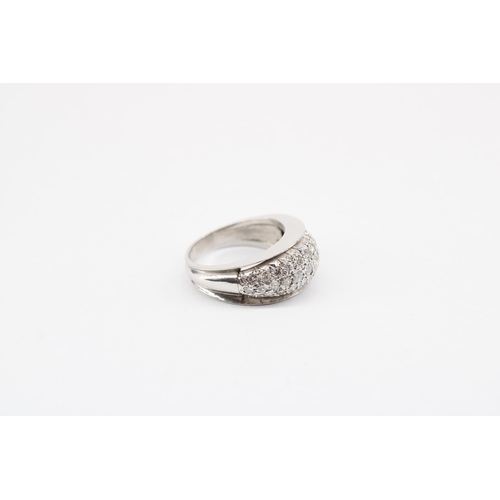 17 - A brilliant cut diamond three row bombe style band ring. Size P. Tests platinum. Weight 10.54 grams