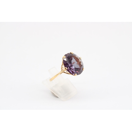 20 - A synthetic colour change sapphire single stone ring. Size P. Tests gold 18ct. Weight 6.72 grams.