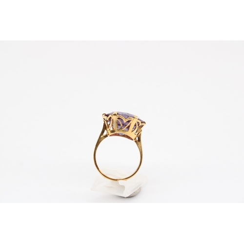 20 - A synthetic colour change sapphire single stone ring. Size P. Tests gold 18ct. Weight 6.72 grams.