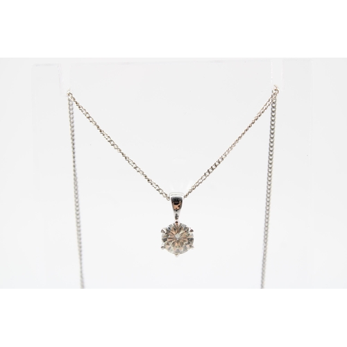 21 - A 9ct gold brilliant cut diamond solitaire pendant. Suspended from a chain stamped 750. Estimated di... 