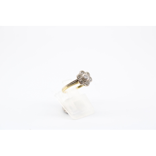 24 - A brilliant cut diamond daisy cluster ring. Estimated 0.50ct, H/I VS2/SI1. Size M. Tests 18ct. Weigh... 