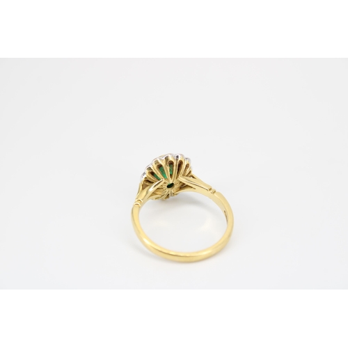 30 - An 18ct gold oval emerald and diamond cluster ring. Size O. Weight 4.78 grams