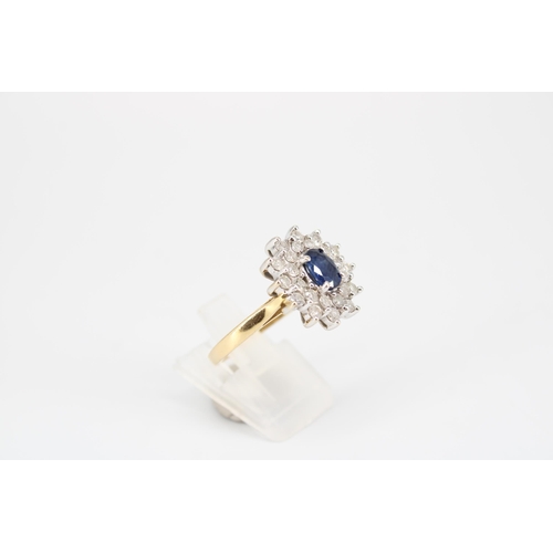 31 - An oval sapphire and diamond cluster ring. Estimated total diamond wight 1.20cts. Tests 18ct. Size S... 