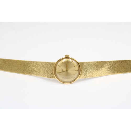  An 18ct Ladies IWC, Featuring an integral bark effect bracelet with a round gold tone dial, hands an... 