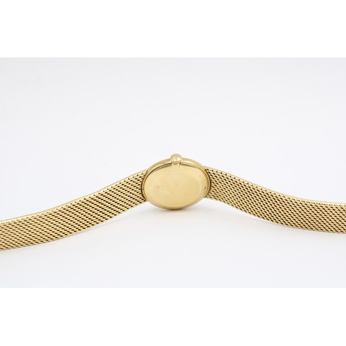  An 18ct Ladies IWC, Featuring an integral bark effect bracelet with a round gold tone dial, hands an... 