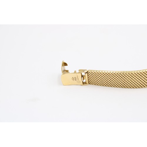  An 18ct Ladies IWC, Featuring an integral bark effect bracelet with a round gold tone dial, hands an... 