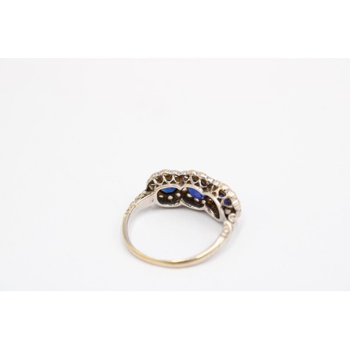 7 - A 1970's Sapphire & Diamond Triple Halo Cluster Ring featuring decorative gallery and carved sho... 