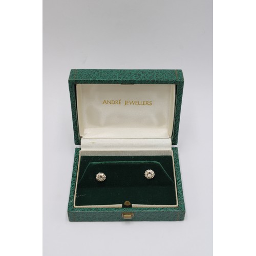 1 - A pair of diamond cluster earrings. Estimated total weight 0.45cts. Stamped 18ct. Weight 2.54 grams