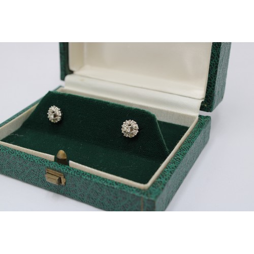 1 - A pair of diamond cluster earrings. Estimated total weight 0.45cts. Stamped 18ct. Weight 2.54 grams