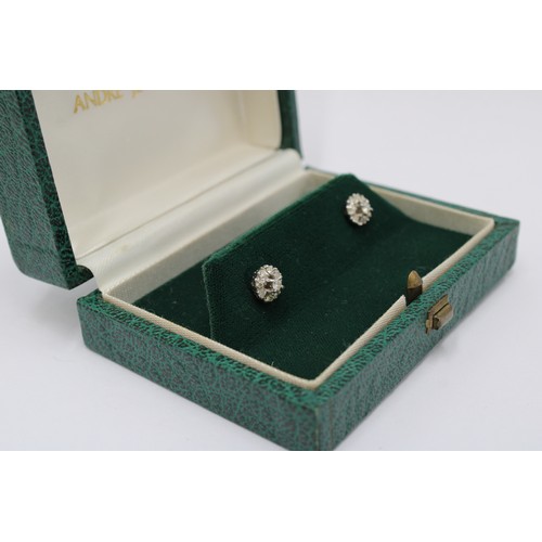 1 - A pair of diamond cluster earrings. Estimated total weight 0.45cts. Stamped 18ct. Weight 2.54 grams