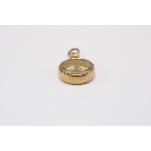 3 - A 9ct gold compass charm. Weight 7.57 grams