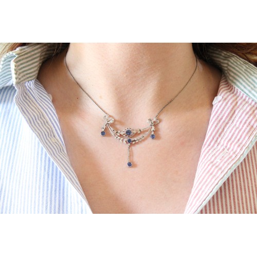20 - An Early 20th Century Edwardian Diamond & Sapphire Necklace, Featuring a central marquise-shaped... 