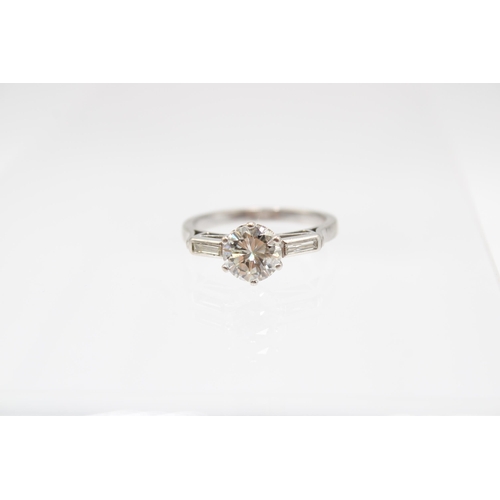 26 - An Unmarked Art Deco 18ct Tested Diamond Solitaire with Baguette Diamond Set Shoulders. Approximatel... 