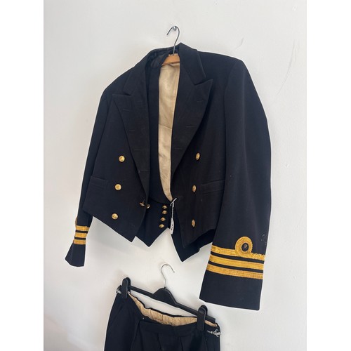 379 - A Royal Navy uniform of a Commander, comprising wool jacket, waistcoat, trousers and two caps