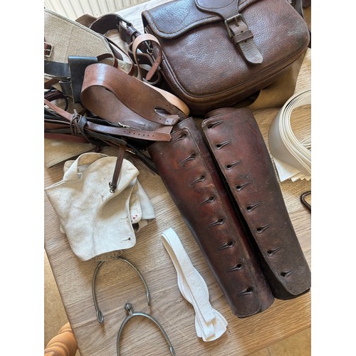 378 - A group of cavalry fittings, First World War era, including a canvas gas mask bag, a pair of leather... 