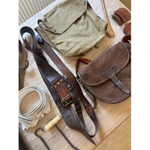 378 - A group of cavalry fittings, First World War era, including a canvas gas mask bag, a pair of leather... 