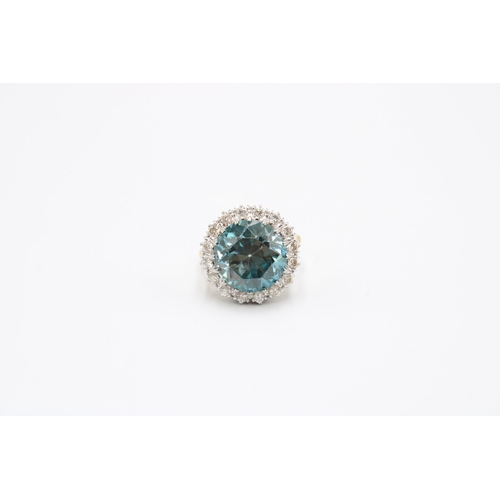 34 - A Good Quality 13.5mm Circular Blue zircon and brilliant cut diamond cluster ring. Size P. Weight 8.... 