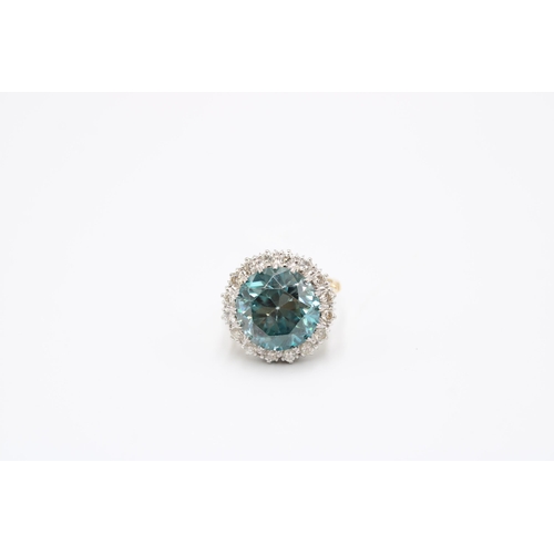 34 - A Good Quality 13.5mm Circular Blue zircon and brilliant cut diamond cluster ring. Size P. Weight 8.... 