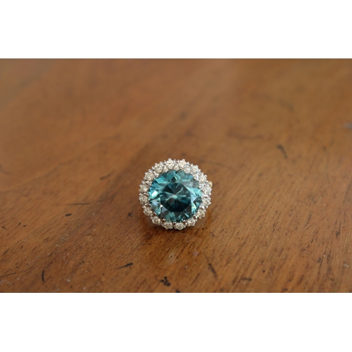 34 - A Good Quality 13.5mm Circular Blue zircon and brilliant cut diamond cluster ring. Size P. Weight 8.... 