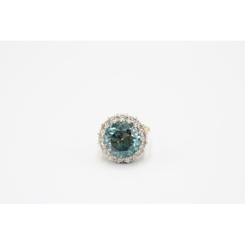 34 - A Good Quality 13.5mm Circular Blue zircon and brilliant cut diamond cluster ring. Size P. Weight 8.... 