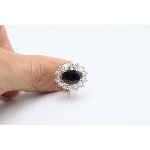 39 - An oval sapphire and diamond cluster ring. Total estimated diamond weight 1.75cts, Sapphire Approxim... 