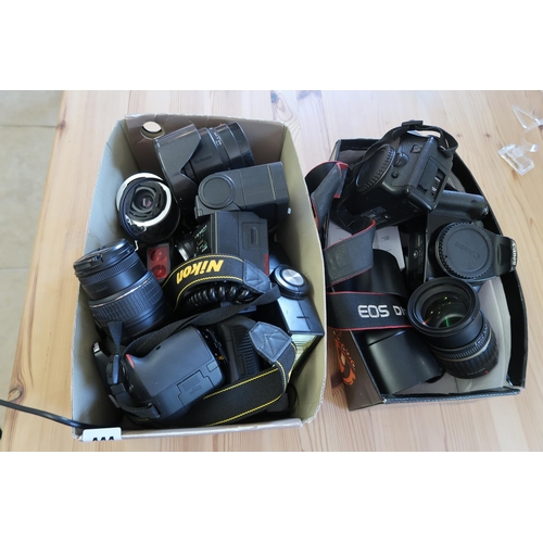 444 - An assorted Group of Nikon & Canon Cameras with accesories to include lenses, Flashes, covers ec... 