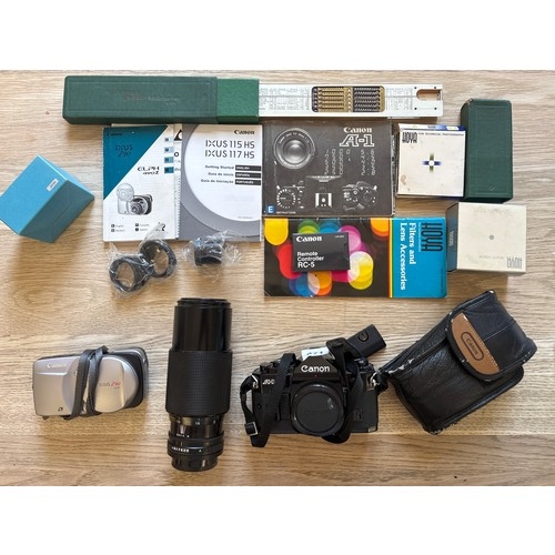 471 - A Canon A1 SLR camera, With 70 - 210 Lens. As well as a Canon IXUS Z90 with accessories