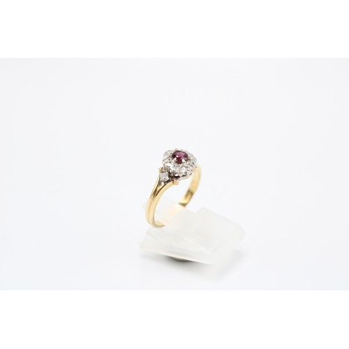  An 18ct Ruby & Diamond Cluster Ring Featuring a pierced shoulder design with ascent stones and c... 