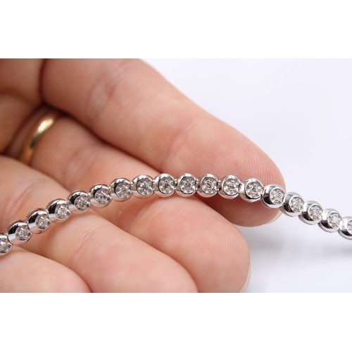  A 9ct White Gold Diamond Line Bracelet with Illusion Set Circular Settings&nbsp;Weight: 11g Length: ... 