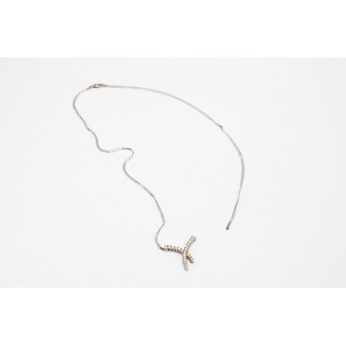  A 9ct White Gold Broken Necklace, Flat Curb Link Design with central diamond cross over pendant, Set... 