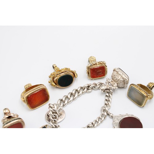  A collection of eleven hardstone fob seals, late 19th and early 20th centuries, bloodstone, carnelia... 