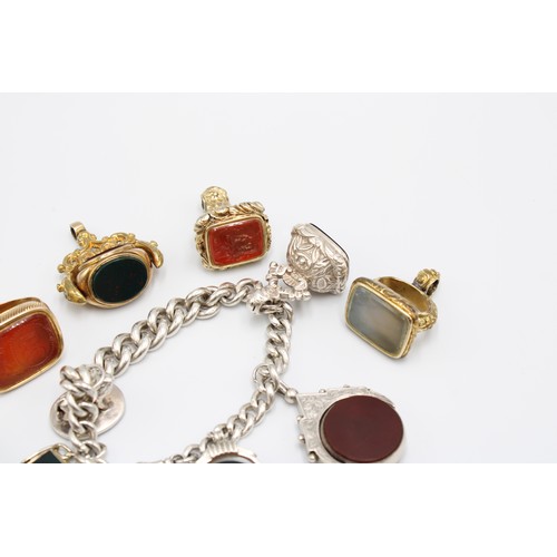  A collection of eleven hardstone fob seals, late 19th and early 20th centuries, bloodstone, carnelia... 