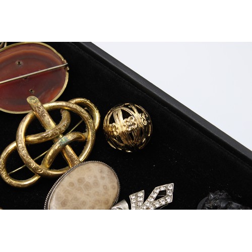 An interesting collection of jewellery, late 18th century and later, including 24 brooches, some Etr... 
