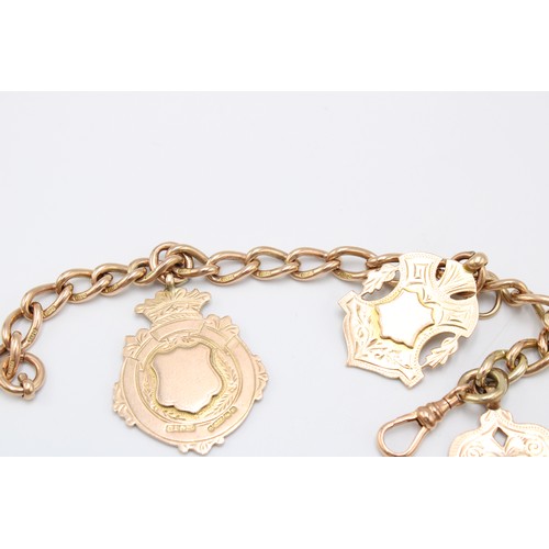  A 9ct gold fob chain bracelet and pendants, the chain marked 9 and 375, the three heraldic medallion... 