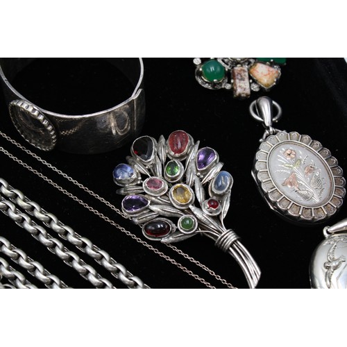  A group of silver jewellery, comprising six brooches, two set with hardstones and semi-precious gems... 