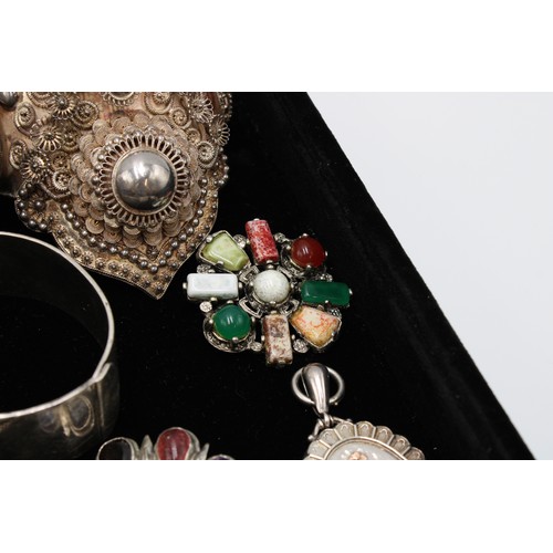  A group of silver jewellery, comprising six brooches, two set with hardstones and semi-precious gems... 