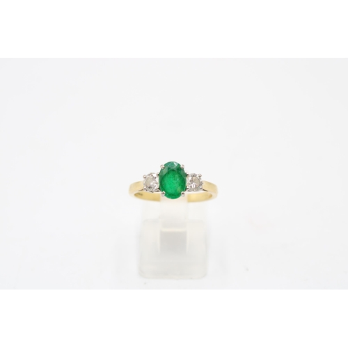5 - An 18ct gold emerald and diamond three stone ring. Emerald estimated 1.08ct. Diamonds estimated tota... 