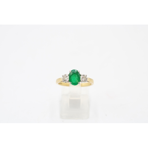 5 - An 18ct gold emerald and diamond three stone ring. Emerald estimated 1.08ct. Diamonds estimated tota... 
