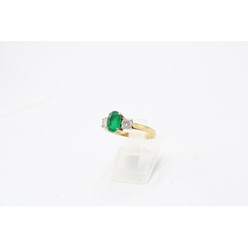 5 - An 18ct gold emerald and diamond three stone ring. Emerald estimated 1.08ct. Diamonds estimated tota... 