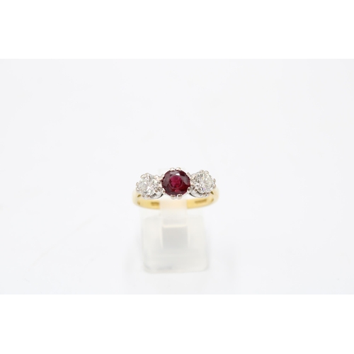 7 - An 18ct gold ruby and diamond three stone ring. Estimated ruby weight 1ct. Estimated total diamond w... 