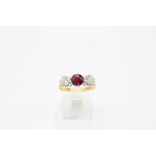 7 - An 18ct gold ruby and diamond three stone ring. Estimated ruby weight 1ct. Estimated total diamond w... 