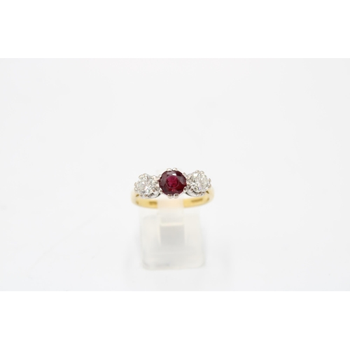 7 - An 18ct gold ruby and diamond three stone ring. Estimated ruby weight 1ct. Estimated total diamond w... 