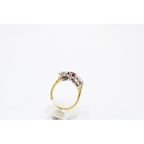 7 - An 18ct gold ruby and diamond three stone ring. Estimated ruby weight 1ct. Estimated total diamond w... 