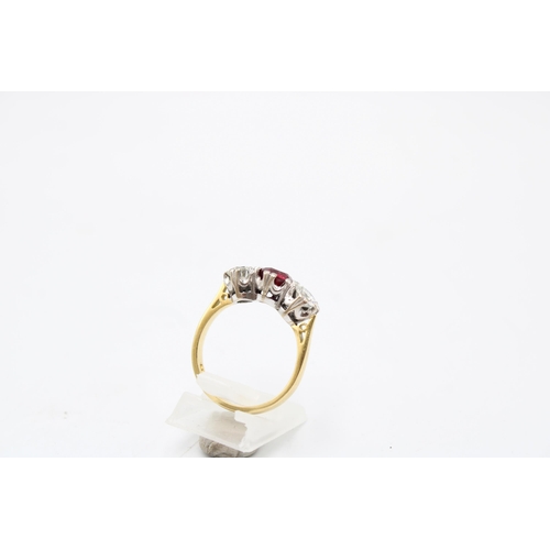 7 - An 18ct gold ruby and diamond three stone ring. Estimated ruby weight 1ct. Estimated total diamond w... 