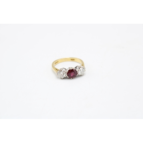 7 - An 18ct gold ruby and diamond three stone ring. Estimated ruby weight 1ct. Estimated total diamond w... 