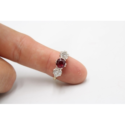 7 - An 18ct gold ruby and diamond three stone ring. Estimated ruby weight 1ct. Estimated total diamond w... 