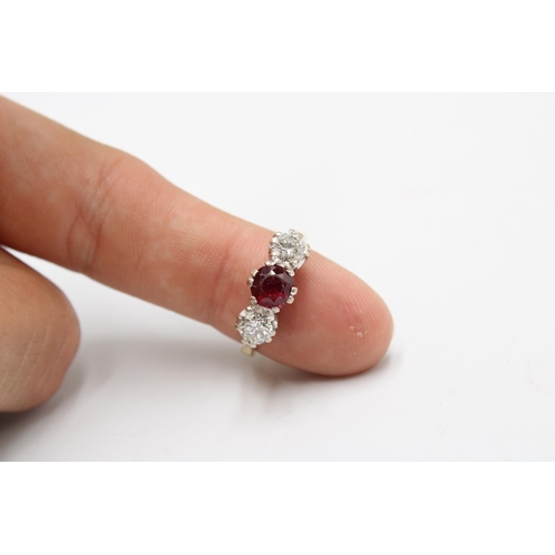 7 - An 18ct gold ruby and diamond three stone ring. Estimated ruby weight 1ct. Estimated total diamond w... 
